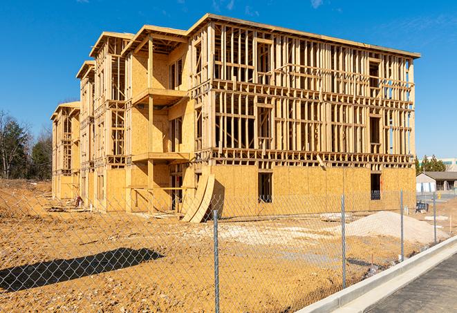 a temporary chain link fence locking away a building under renovation, serving as a security tool in Elburn, IL